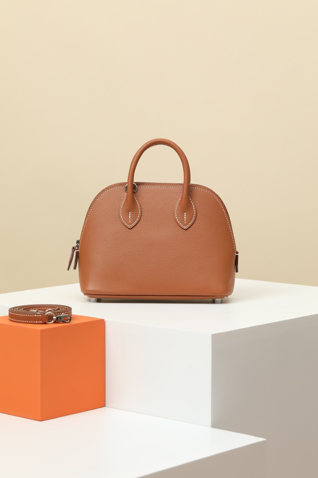 Hermès Mini Bolide 1923 18 – Evercolor Calfskin CK37 Gold PHW comparison image 1 sourced from womanlvbag.com