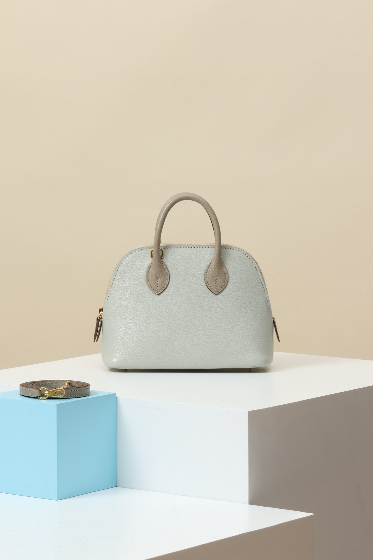 Hermès Mini Bolide 1923 – Mysore Goatskin 81 Gris Tourterelle / 80 Gris Perle GHW comparison image 2 sourced from womanlvbag.com