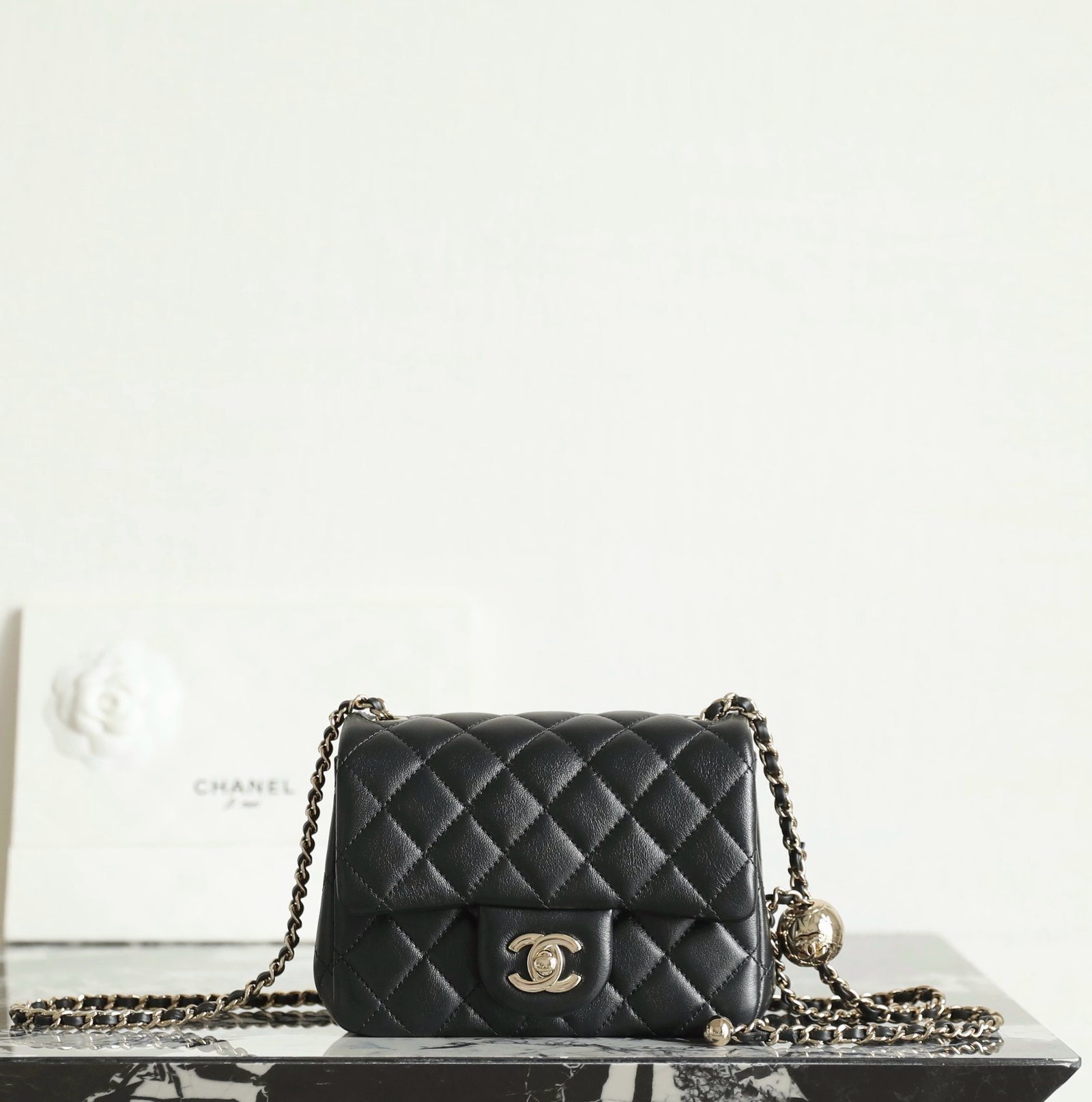 CHANEL Mini Square "Golden Ball" Adjustable Flap Bag – Black Lambskin with 14K Light Gold Hardware detail image 1 sourced from womanlvbag.com