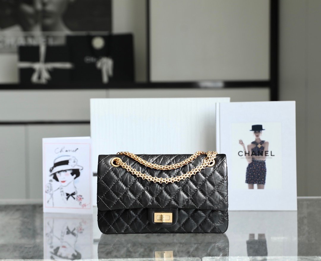 CHANEL Medium 2.55 Reissue Flap Bag – Black Aged Calfskin with 24K Vintage Gold Mademoiselle Lock detail image 1 sourced from womanlvbag.com