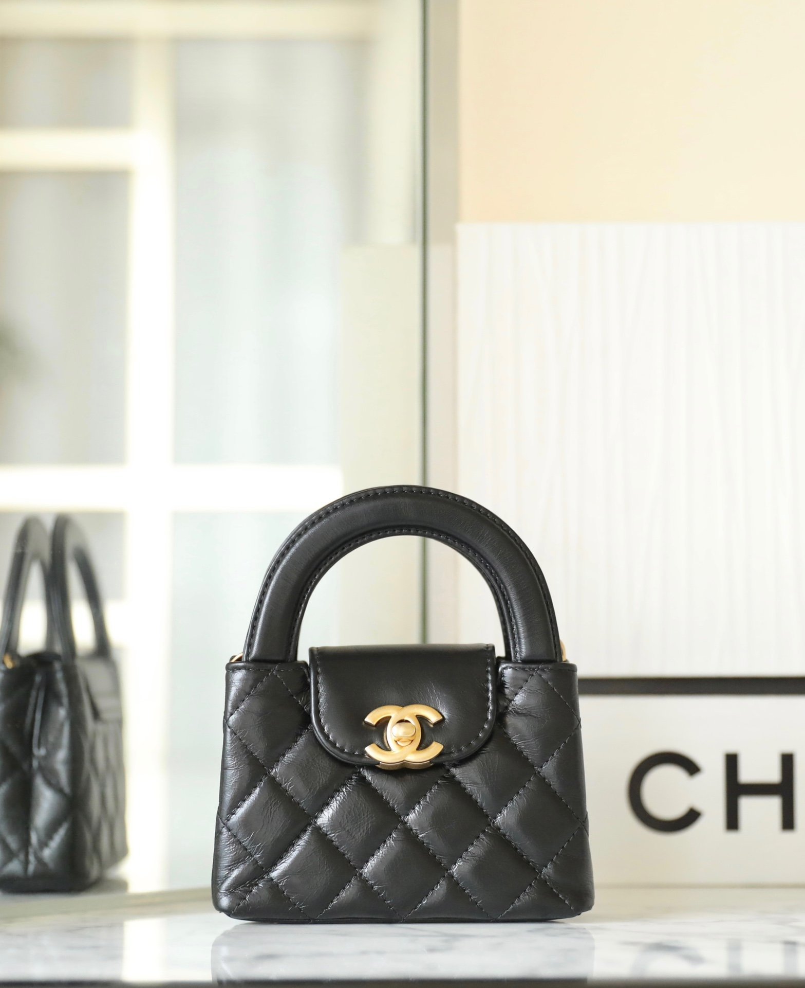 CHANEL Mini Kelly Top Handle Bag – Black Calfskin with 24K Vintage Gold Hardware detail image 1 sourced from womanlvbag.com