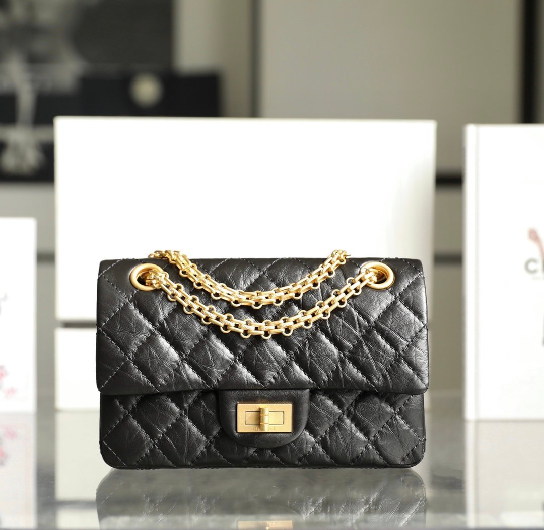 CHANEL Mini 2.55 Reissue Flap Bag – Black Aged Calfskin with 24K Vintage Gold Mademoiselle Lock detail image 1 sourced from womanlvbag.com