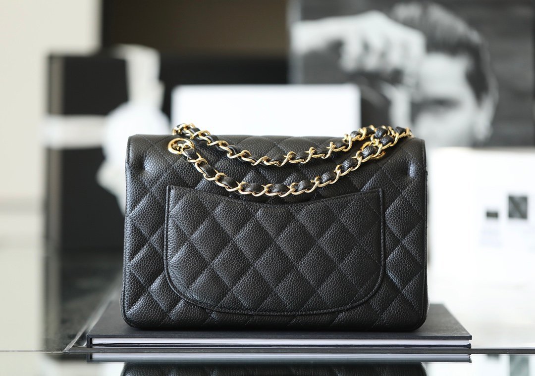 Classic Chanel bag detail: quilted caviar leather, CC turn-lock, and gold chain on Chanel Classic Flap
