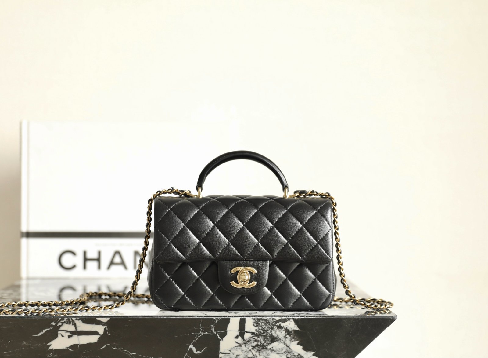 CHANEL Mini Flap Bag with Top Handle – Black Lambskin with 14K Light Gold Hardware detail image 1 sourced from womanlvbag.com