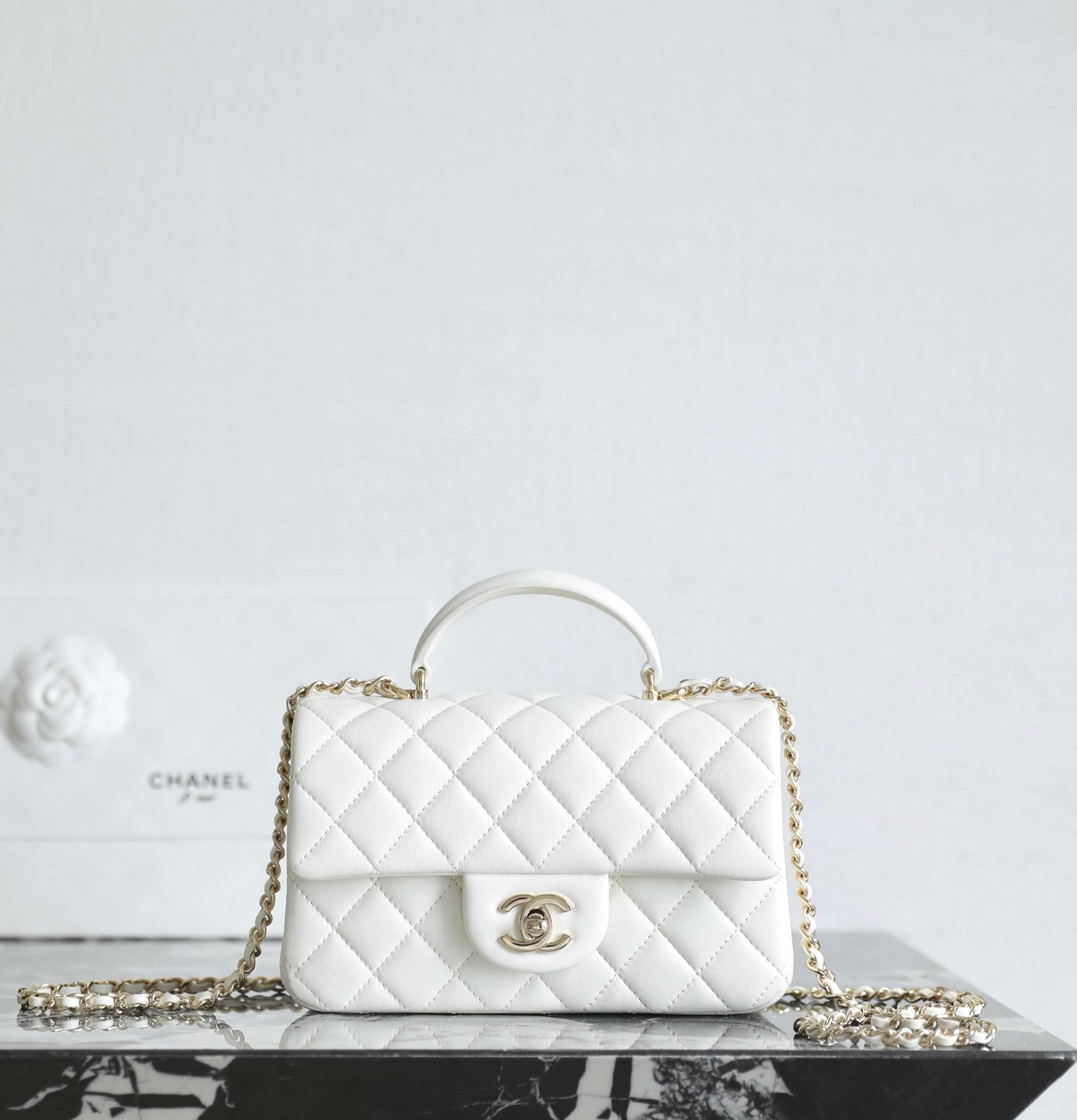 CHANEL Mini Flap Bag with Top Handle – White Lambskin with 14K Light Gold Hardware detail image 1 sourced from womanlvbag.com