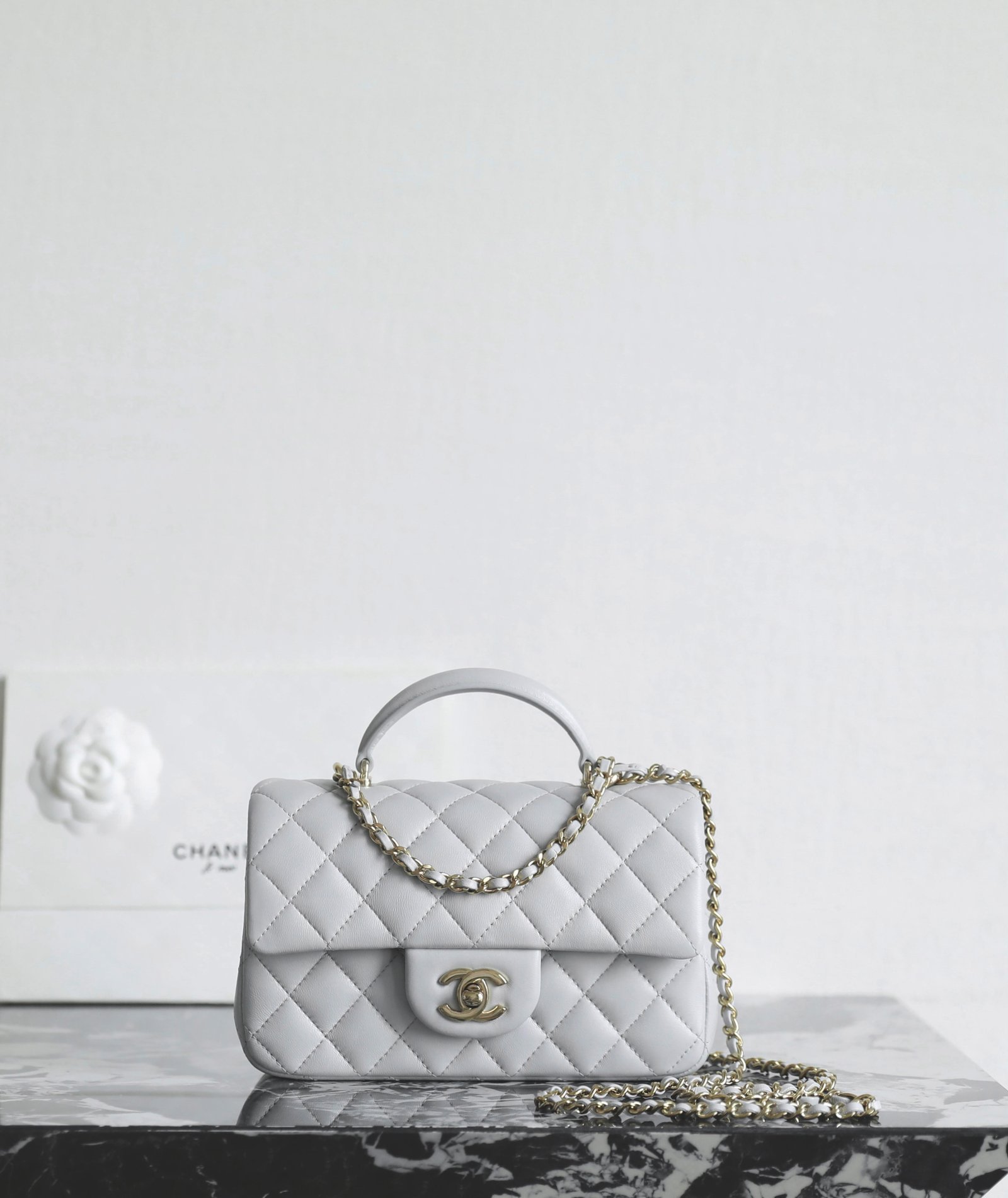 CHANEL Mini Flap Bag with Top Handle – Light Grey Lambskin with 14K Light Gold Hardware detail image 1 sourced from womanlvbag.com